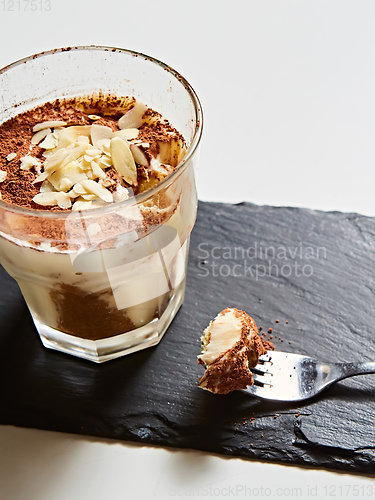 Image of Tiramisu in glass, traditional coffee flavored Italian dessert made of ladyfingers and mascarpone.