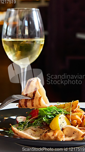 Image of The grilled squid with salad. Shallow dof.