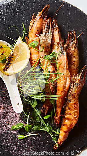 Image of Grilled shrimp skewers. Seafood, shelfish. Shrimps Prawns skewers with herbs, garlic and lemon.