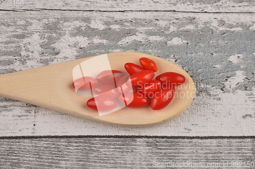 Image of Gojiberry on wooden spoon and timber