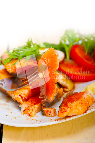 Image of grilled samon filet with vegetables salad