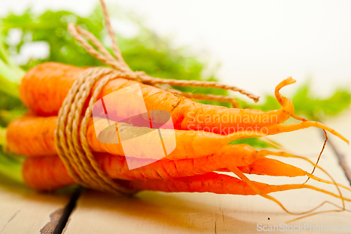 Image of baby carrots bunch tied with rope