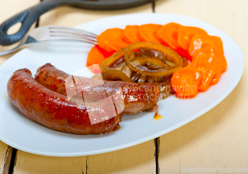 Image of beef sausages cooked on iron skillet