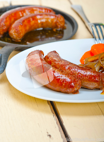 Image of beef sausages cooked on iron skillet