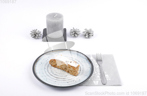 Image of Christmas stollen on plate with christmas decoration