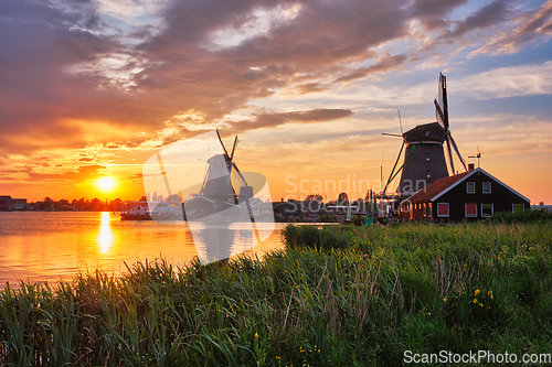 Image of Windmills at Zaanse Schans in Holland on sunset. Zaandam, Nether
