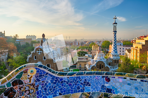 Image of Barcelona city view from Guell Park. Sunrise view of colorful mosaic building in Park Guell