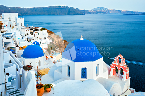 Image of Famous view from viewpoint of Santorini Oia village with blue dome of greek orthodox Christian church