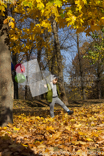 Image of beautiful boy with a red, green and blue balloon