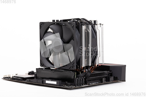 Image of computer PC mainboard with CPU cooler on white