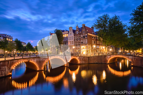 Image of Amterdam canal, bridge and medieval houses in the evening