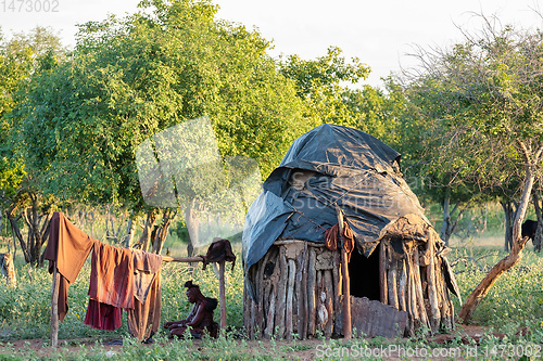 Image of old himba woman in front of hut, Namibia Africa