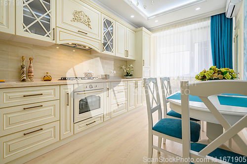 Image of Beige, white and cyan furniture at kitchen in provence style,