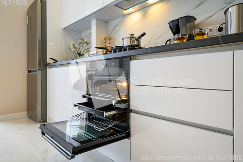 Image of Open electric oven at white kitchen