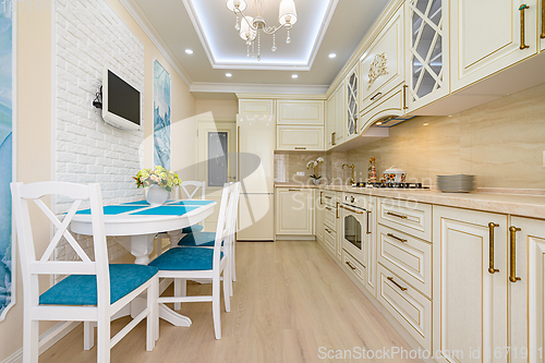 Image of Beige, white and cyan furniture at kitchen in provence style,