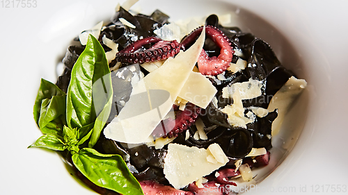 Image of Pasta with black cuttlefish ink, octopuses and parmesan.