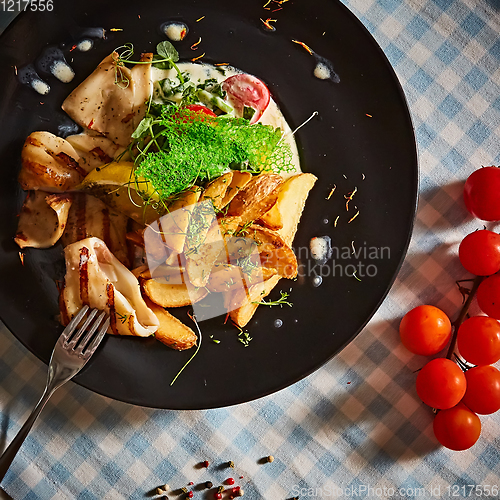 Image of The grilled squid with salad. Shallow dof.