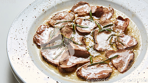 Image of Fried beef tongue with coarse salt. Grilled beef tongue.