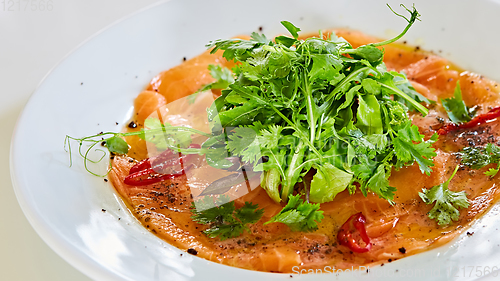 Image of Top view of salmon carpaccio. Shallow dof.