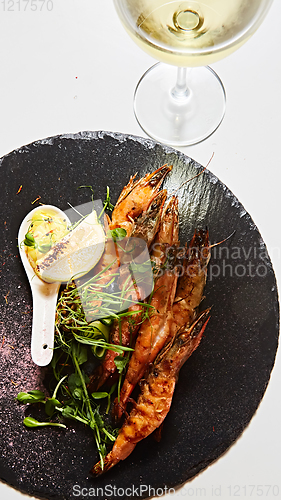 Image of Grilled shrimp skewers. Seafood, shelfish. Shrimps Prawns skewers with herbs, garlic and lemon.