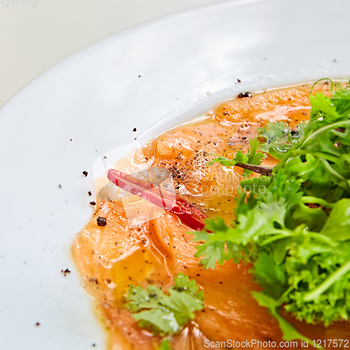 Image of Top view of salmon carpaccio. Shallow dof.