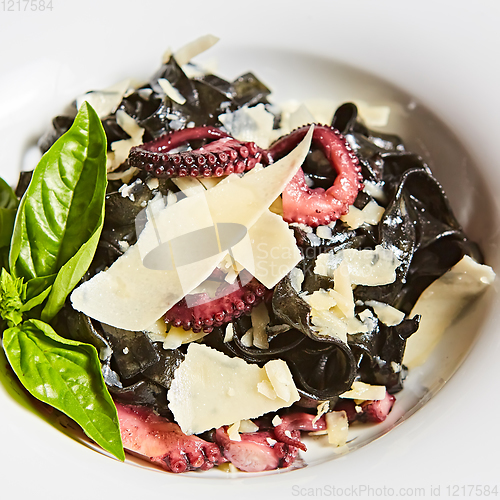 Image of Pasta with black cuttlefish ink, octopuses and parmesan.