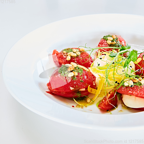 Image of Mozzarella and tomato salad - caprese on the white plate. Shallow dof