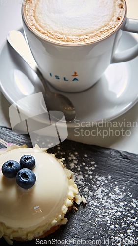 Image of Vanilla bavarian mousse cake with cherries and dark chocolate on top. Made with cream cheese and whipped cream