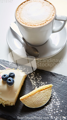 Image of Vanilla bavarian mousse cake with cherries and dark chocolate on top. Made with cream cheese and whipped cream