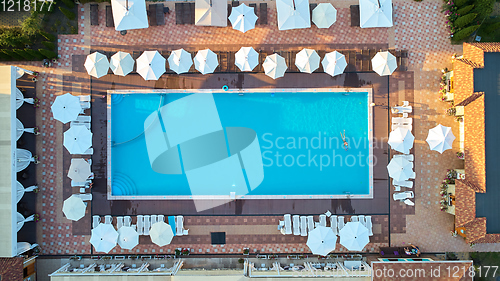 Image of Aerial view on people in swimming pool. Top view of people sunbathing pool.