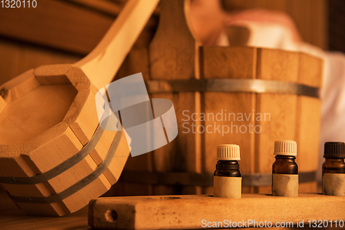 Image of Wooden bath accessories with aromatic oil bottle for bath