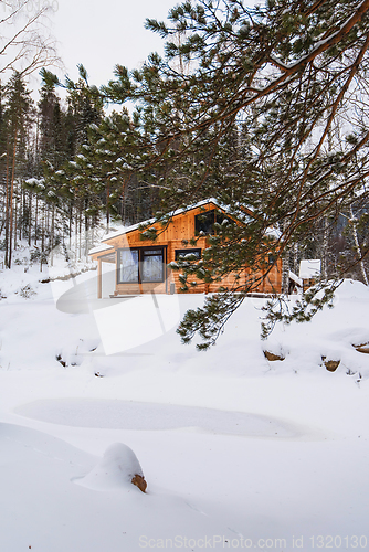 Image of Winter holiday house in forest.