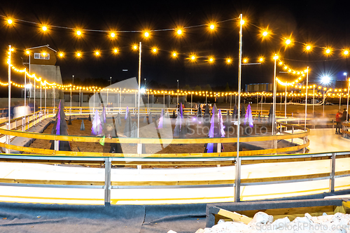 Image of beautiful outdoor ice rink at night with lights