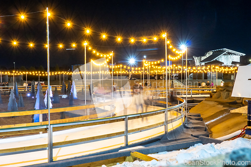 Image of beautiful outdoor ice rink at night with lights