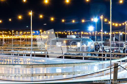 Image of beautiful outdoor ice rink at night with lights