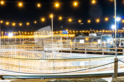 Image of beautiful outdoor ice rink at night with lights