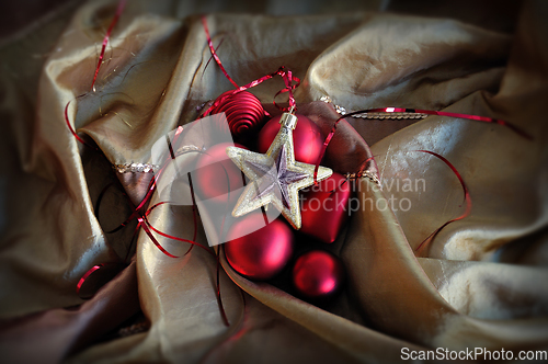 Image of red baubles and golden star christmas ornaments