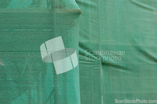 Image of scaffold under debris netting at construction site