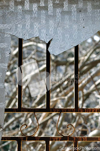 Image of shattered glass rusty door frame