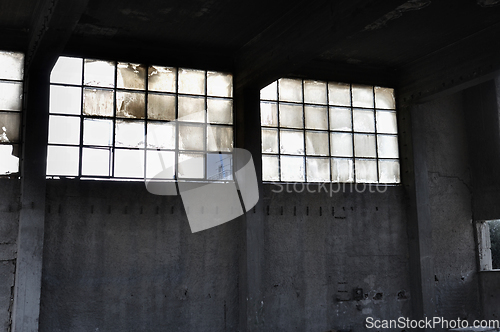 Image of windows and concrete wall in factory interior