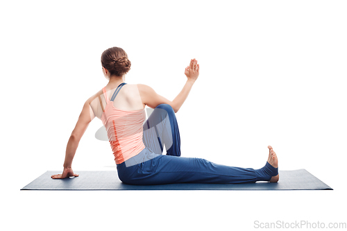 Image of woman practices yoga asana Marichyasana C