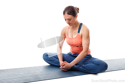 Image of Woman practices yoga asana Baddha konasana
