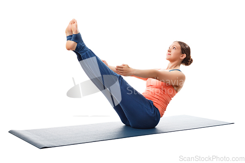 Image of Woman practices yoga asana Paripurna navasana