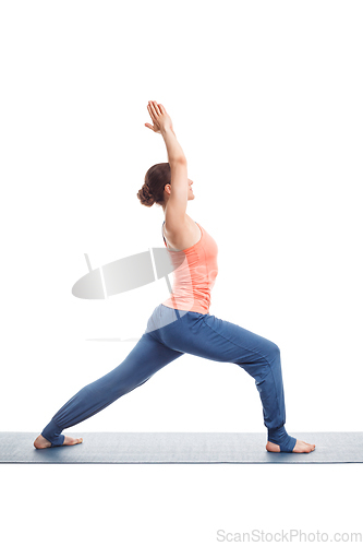 Image of Woman practices yoga asana utthita Virabhadrasana