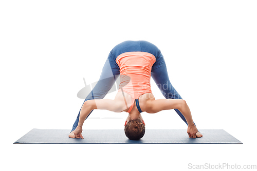 Image of Woman doing yoga asana Prasarita padottanasana