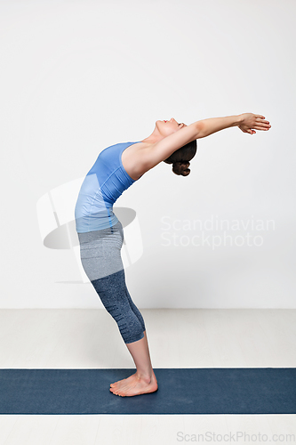 Image of Sporty fit woman practices yoga asana Anuvittasana