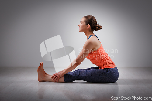 Image of Woman in Ashtanga Vinyasa yoga back bending asana