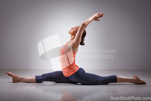 Image of Sporty fit woman doing yoga asana Hanumanasana