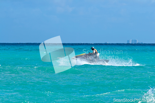 Image of Man riding jet ski