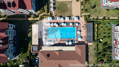 Image of Aerial view on people in swimming pool. Top view of people sunbathing pool.